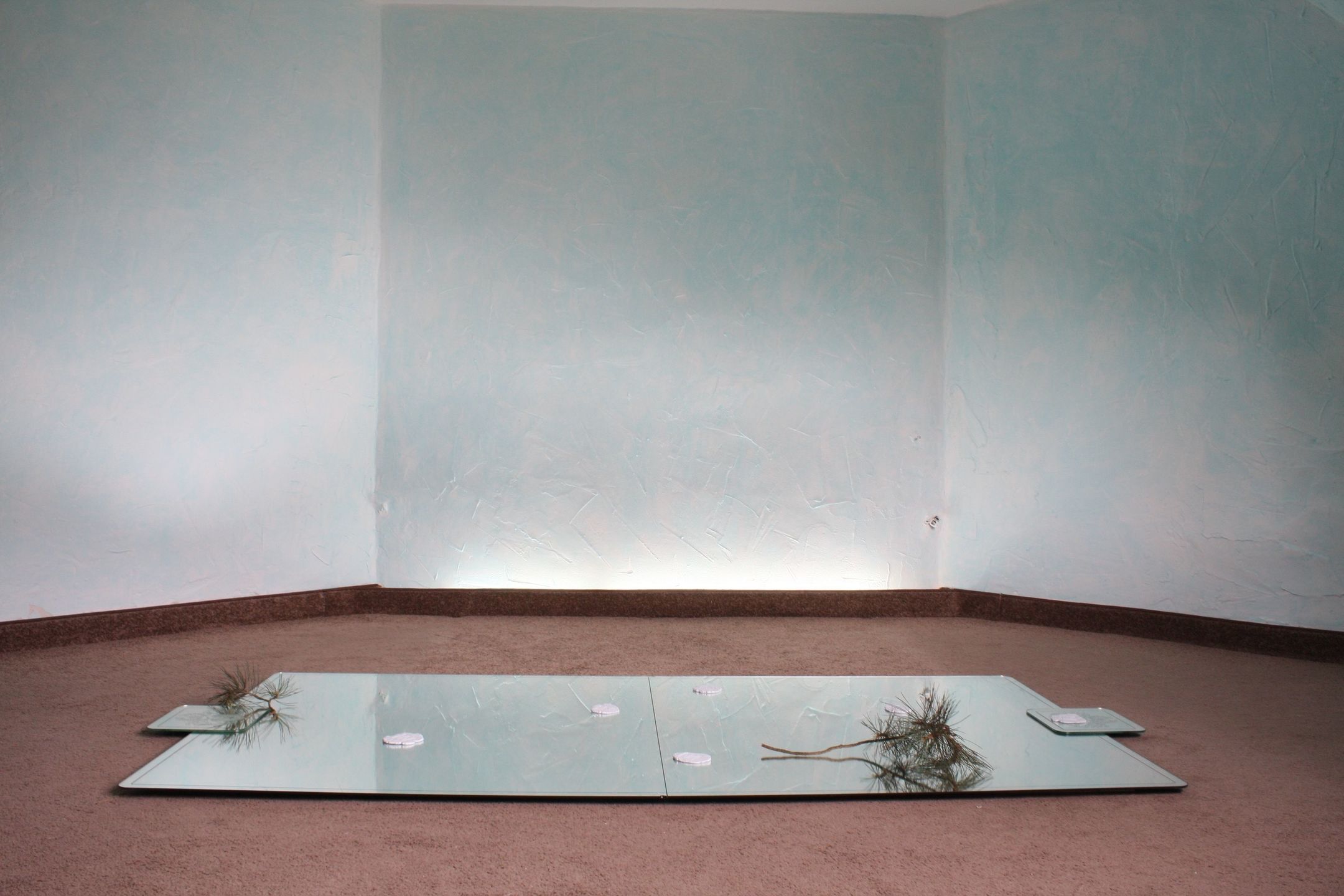 Mirrors on the floor in turquoise room